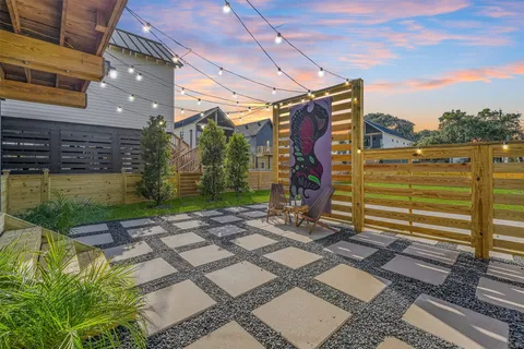 a view of a street with wooden fence
