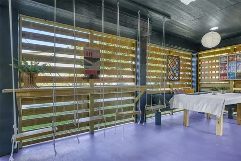 a view of a livingroom with furniture and a window