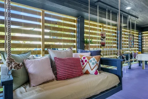 a bedroom with furniture and a large window