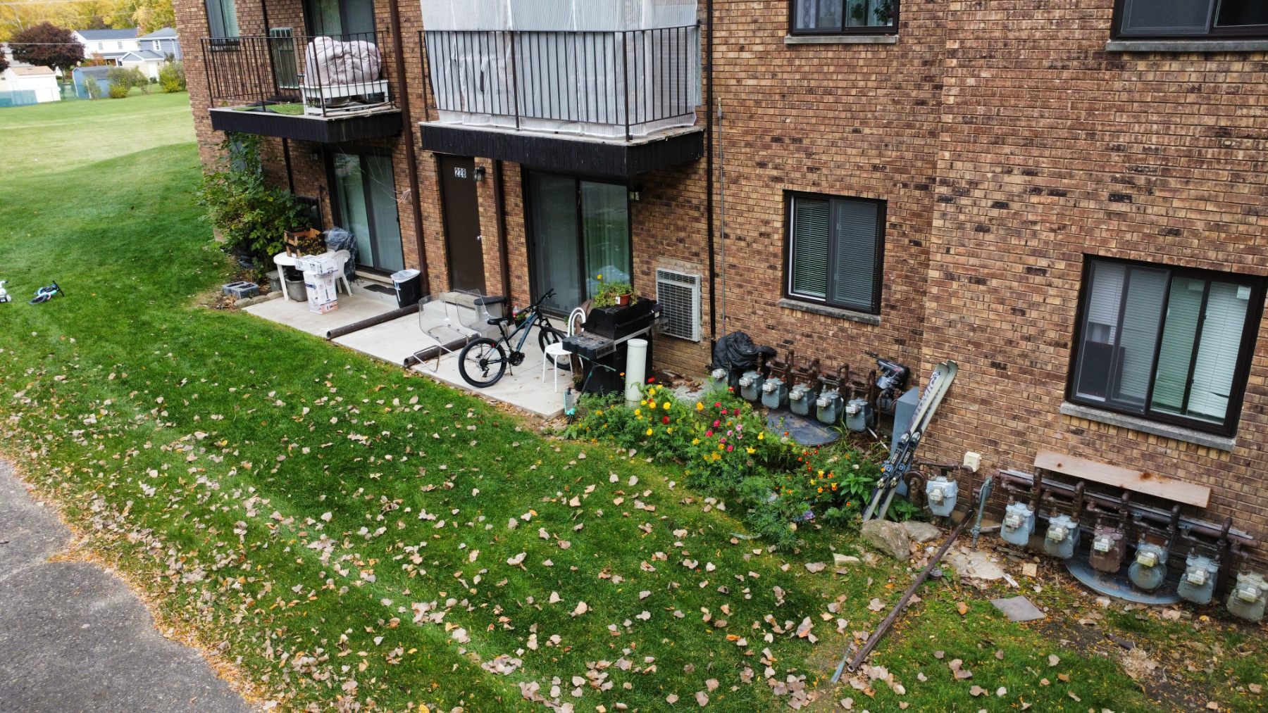 224-228 East Rimini Court Palatine, IL 60067 - Photo 20 of 24 a view of a brick house with a small yard and lawn chairs with a fire pit