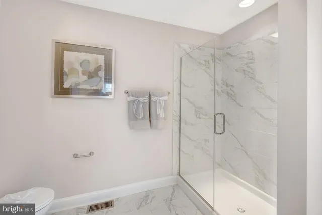 a bathroom with a shower and toilet