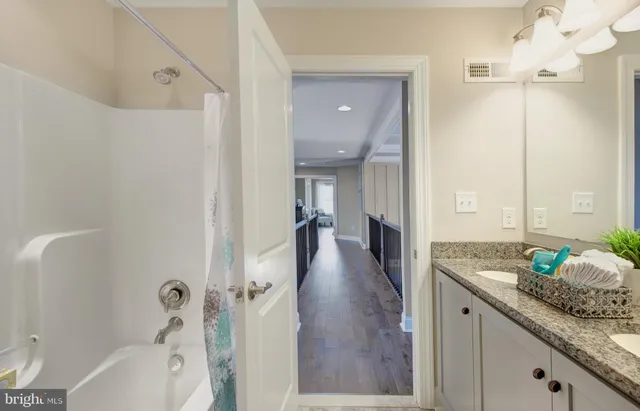 a spacious bathroom with a granite countertop sink and a mirror