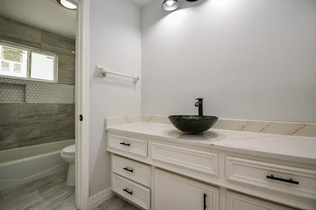 a bathroom with a sink a mirror and bathtub