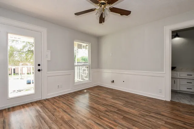 wooden floor in an empty room with a window