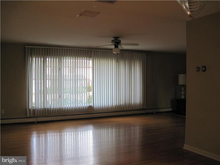7 Greentree Road Hamilton, NJ 08619 - Photo 13 of 18 an empty room with wooden floor and windows