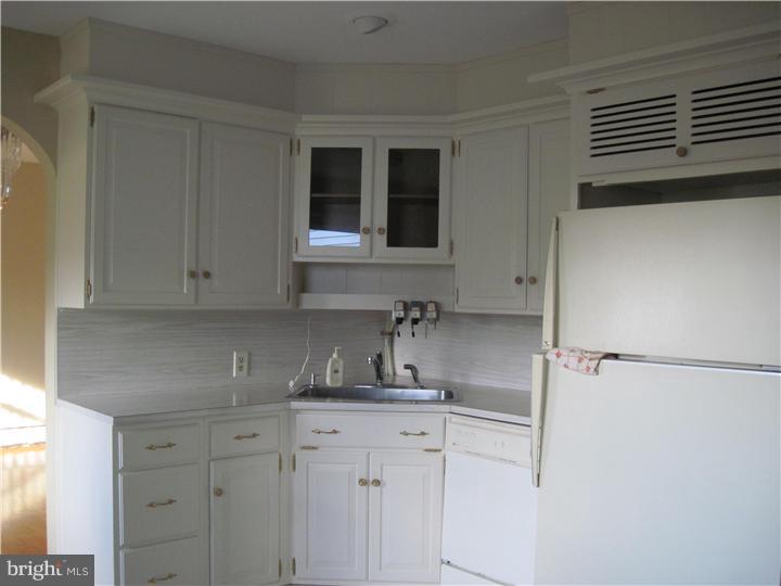 7 Greentree Road Hamilton, NJ 08619 - Photo 9 of 18 a kitchen with a refrigerator and cabinets
