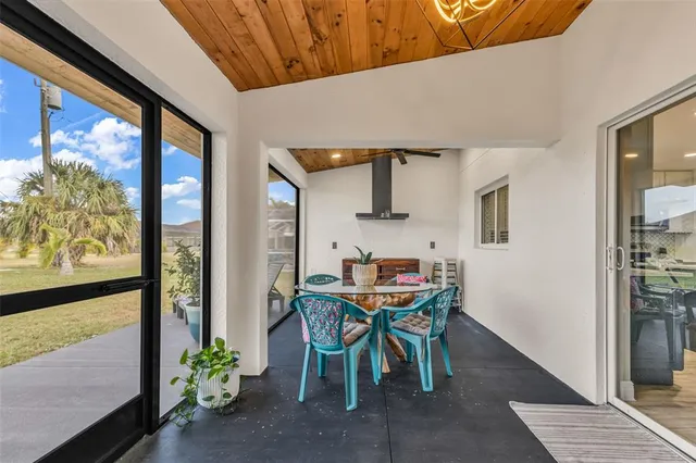 a view of a patio with table and chairs and potted plants