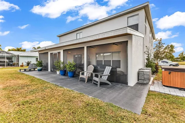 a view of a house with backyard porch and sitting area