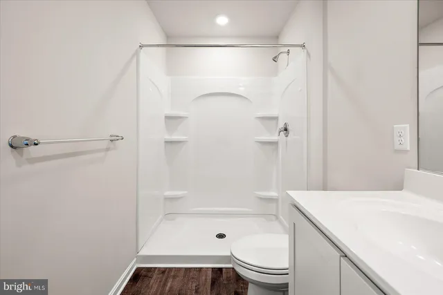 a bathroom with a shower a toilet and a shower