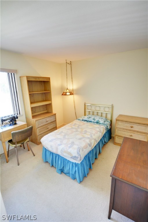 6790 Harmony Road North Port, FL 34287 - Photo 11 of 20 a spacious bedroom with two beds and a desk