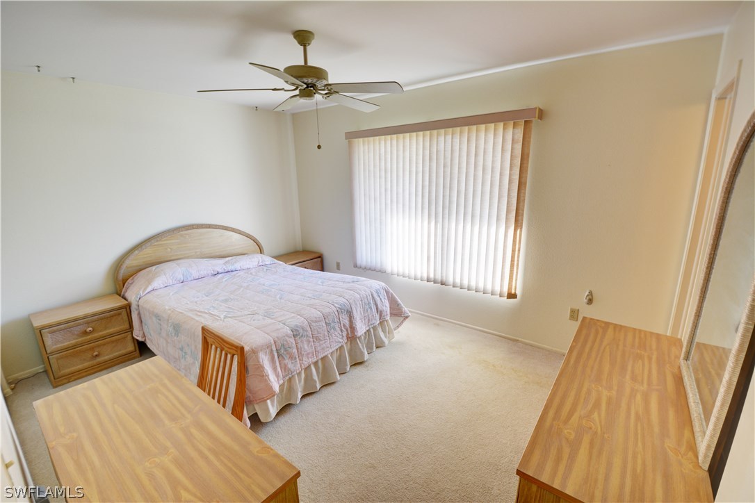 6790 Harmony Road North Port, FL 34287 - Photo 13 of 20 a bedroom with a bed and a chandelier