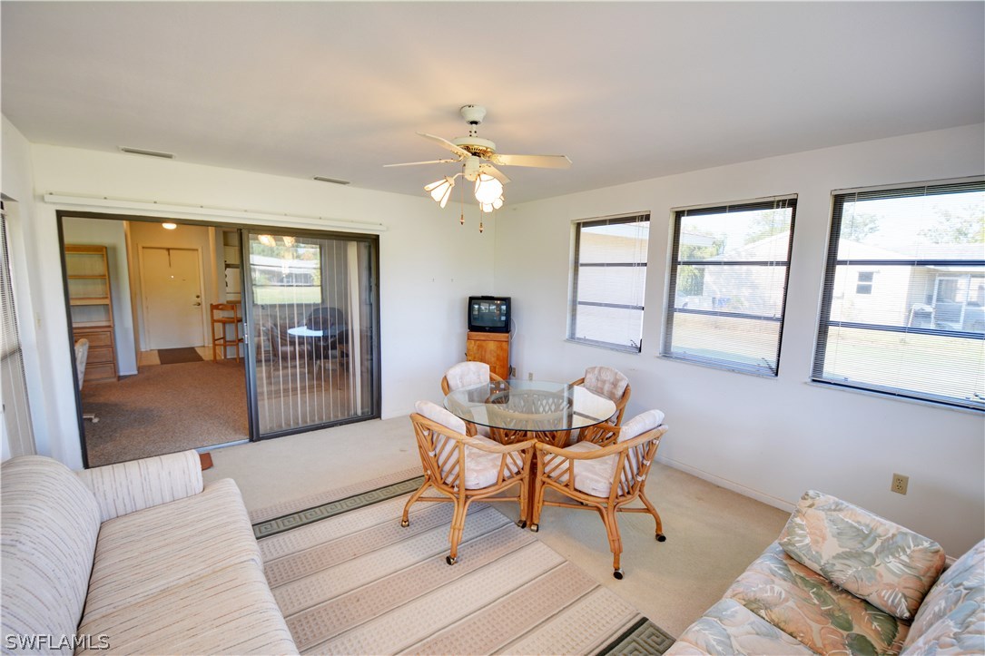 6790 Harmony Road North Port, FL 34287 - Photo 18 of 20 a living room with furniture and a floor to ceiling window