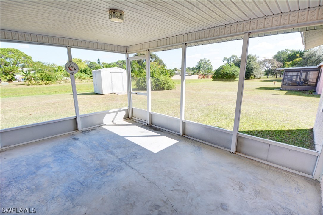 6790 Harmony Road North Port, FL 34287 - Photo 19 of 20 a view of an empty room with wooden floor and door