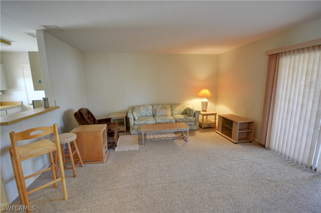 6790 Harmony Road North Port, FL 34287 - Photo 4 of 20 a living room with furniture and a lamp
