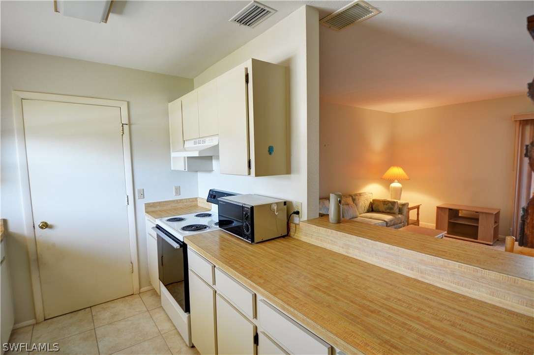6790 Harmony Road North Port, FL 34287 - Photo 5 of 20 a kitchen with a stove and a refrigerator