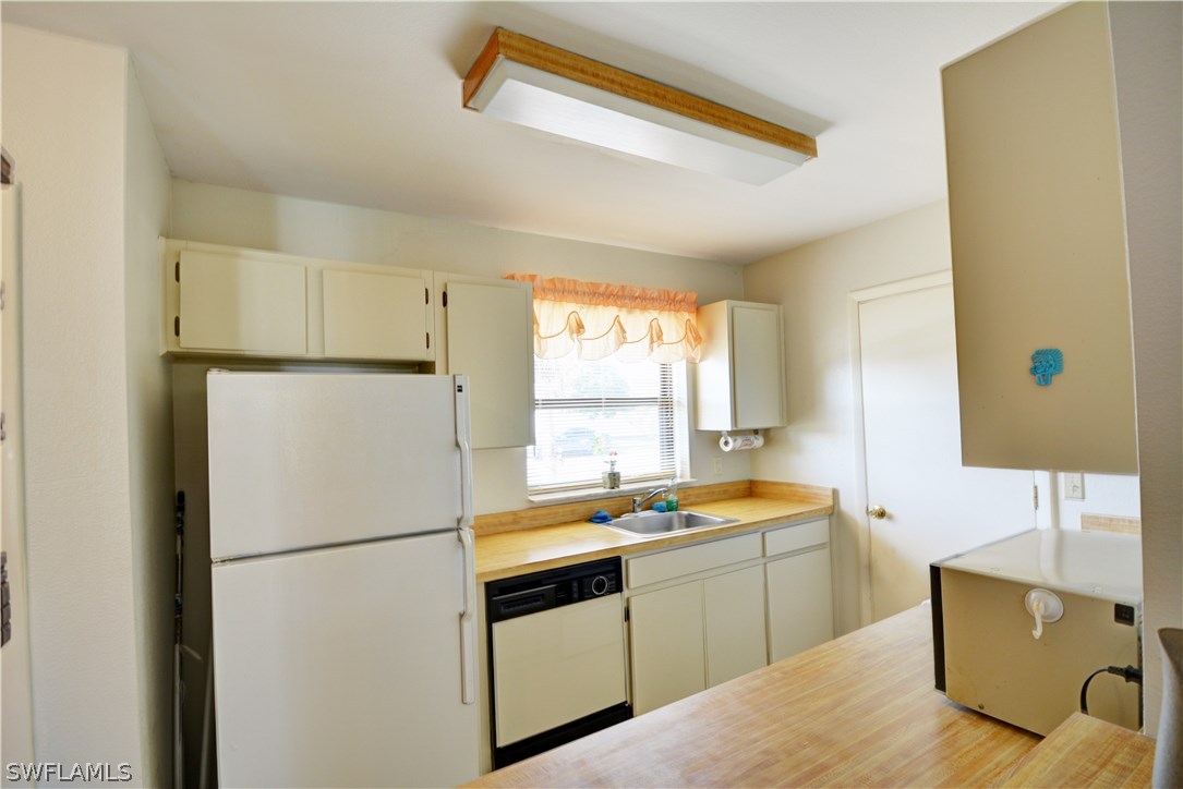 6790 Harmony Road North Port, FL 34287 - Photo 6 of 20 a white refrigerator freezer sitting inside of a kitchen