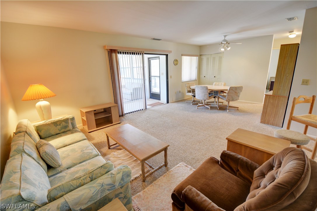 6790 Harmony Road North Port, FL 34287 - Photo 8 of 20 a living room with furniture and a large window