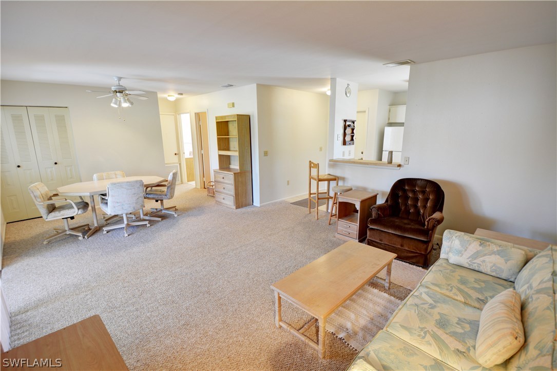 6790 Harmony Road North Port, FL 34287 - Photo 9 of 20 a living room with furniture and a lamp