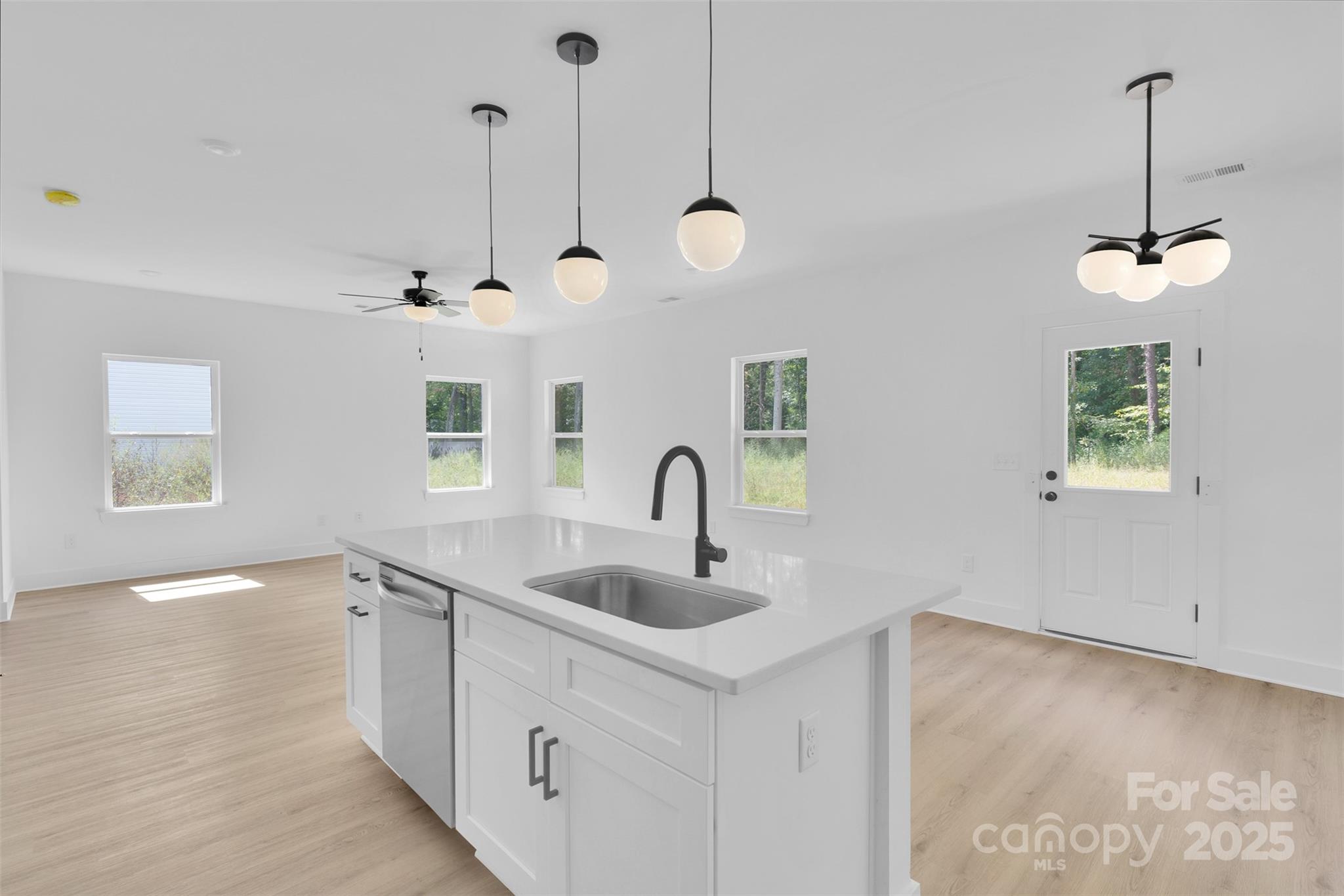 3549 Lake Road Charlotte, NC 28269 - Photo 12 of 34 a view of a kitchen with a sink and dishwasher with wooden floor