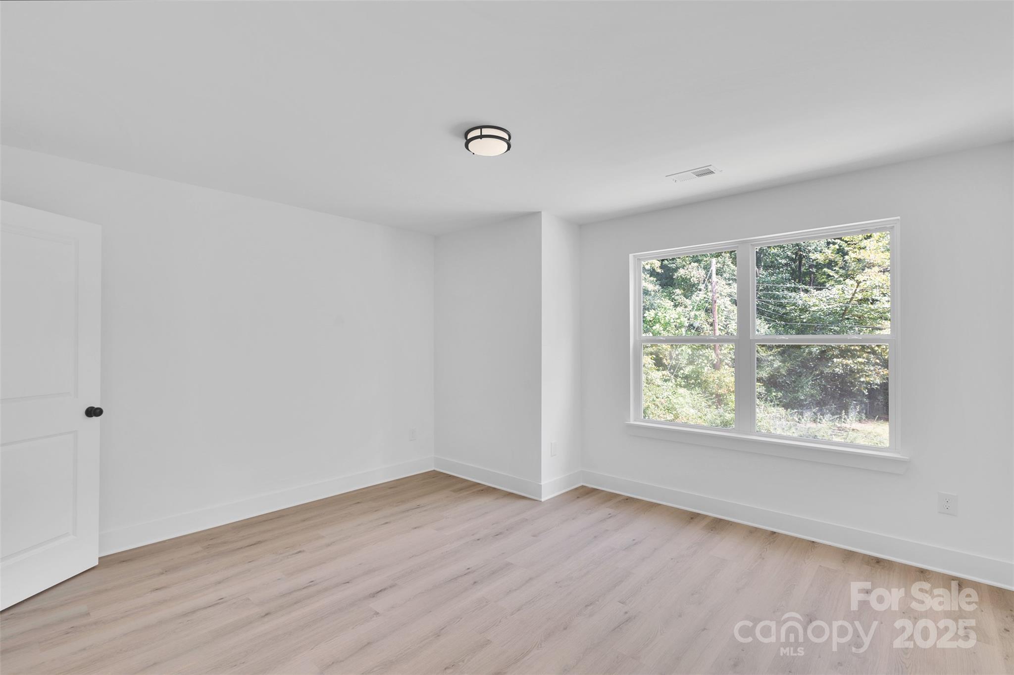 3549 Lake Road Charlotte, NC 28269 - Photo 22 of 34 an empty room with wooden floor and windows