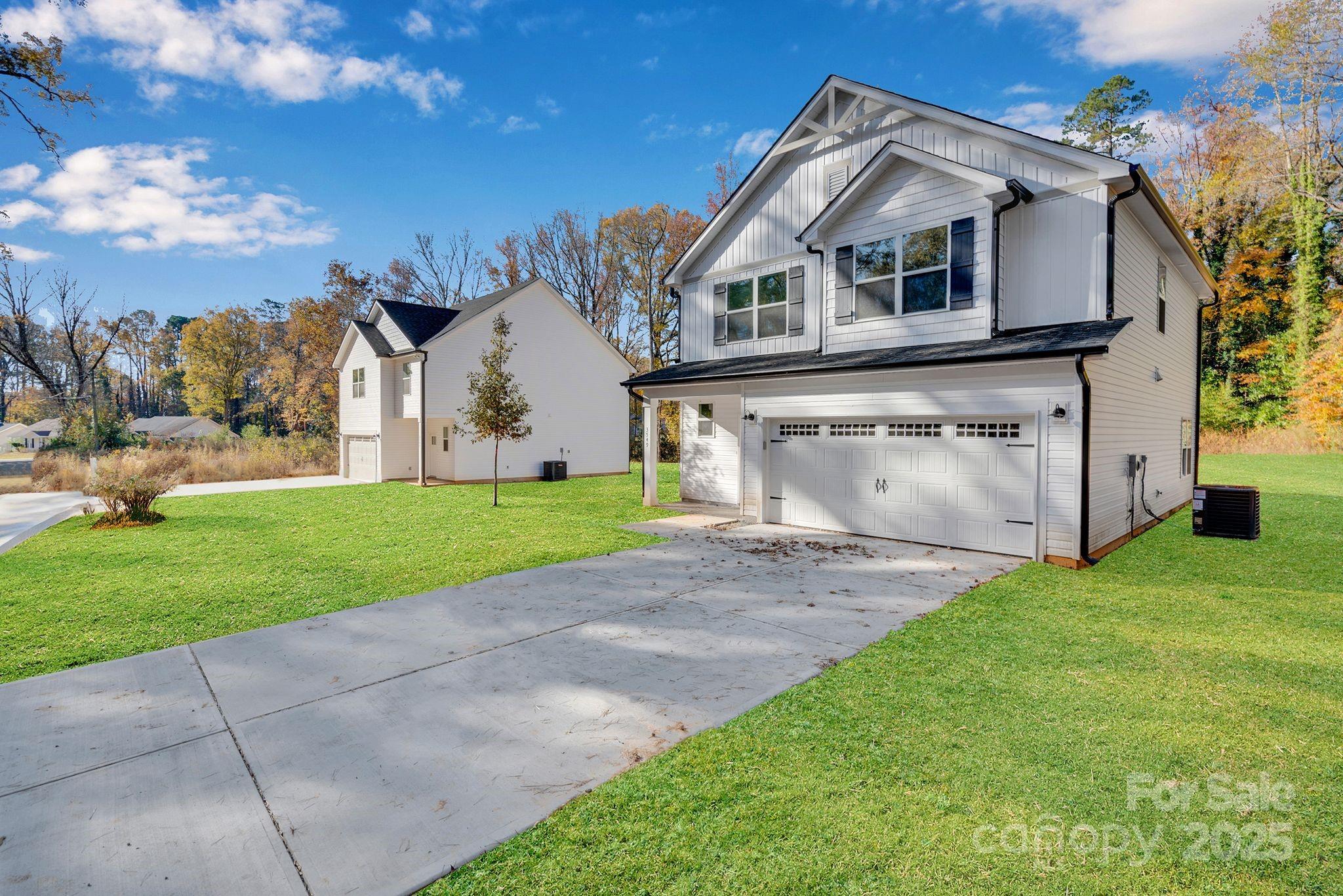 3549 Lake Road Charlotte, NC 28269 - Photo 29 of 34 a view of a white house with a big yard and large trees