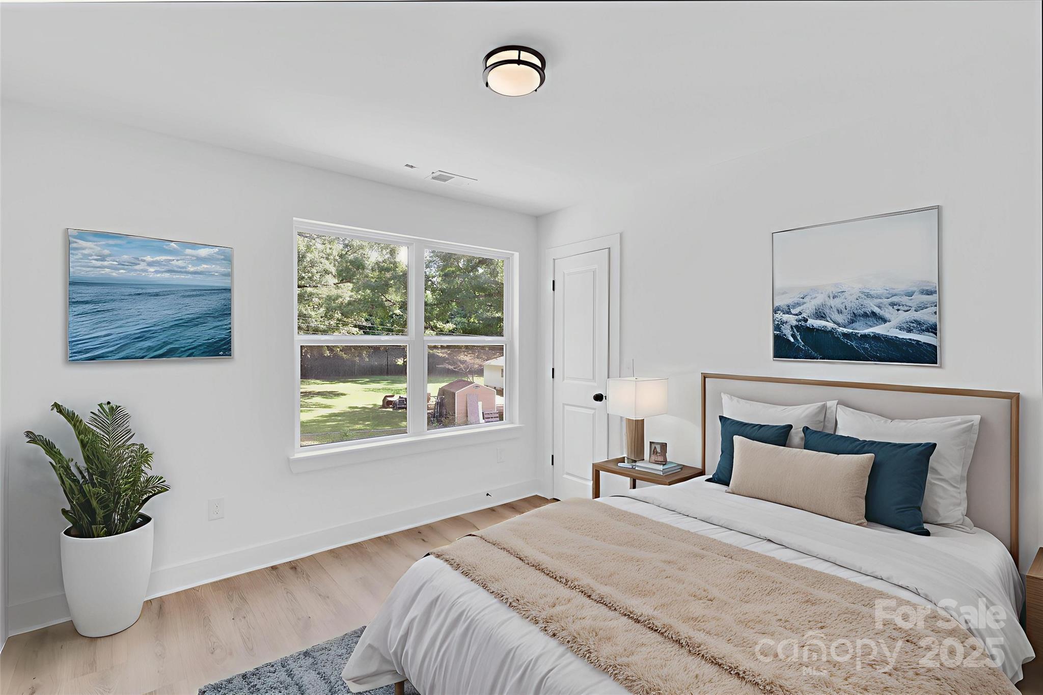 3549 Lake Road Charlotte, NC 28269 - Photo 5 of 34 a bedroom with a bed and a window