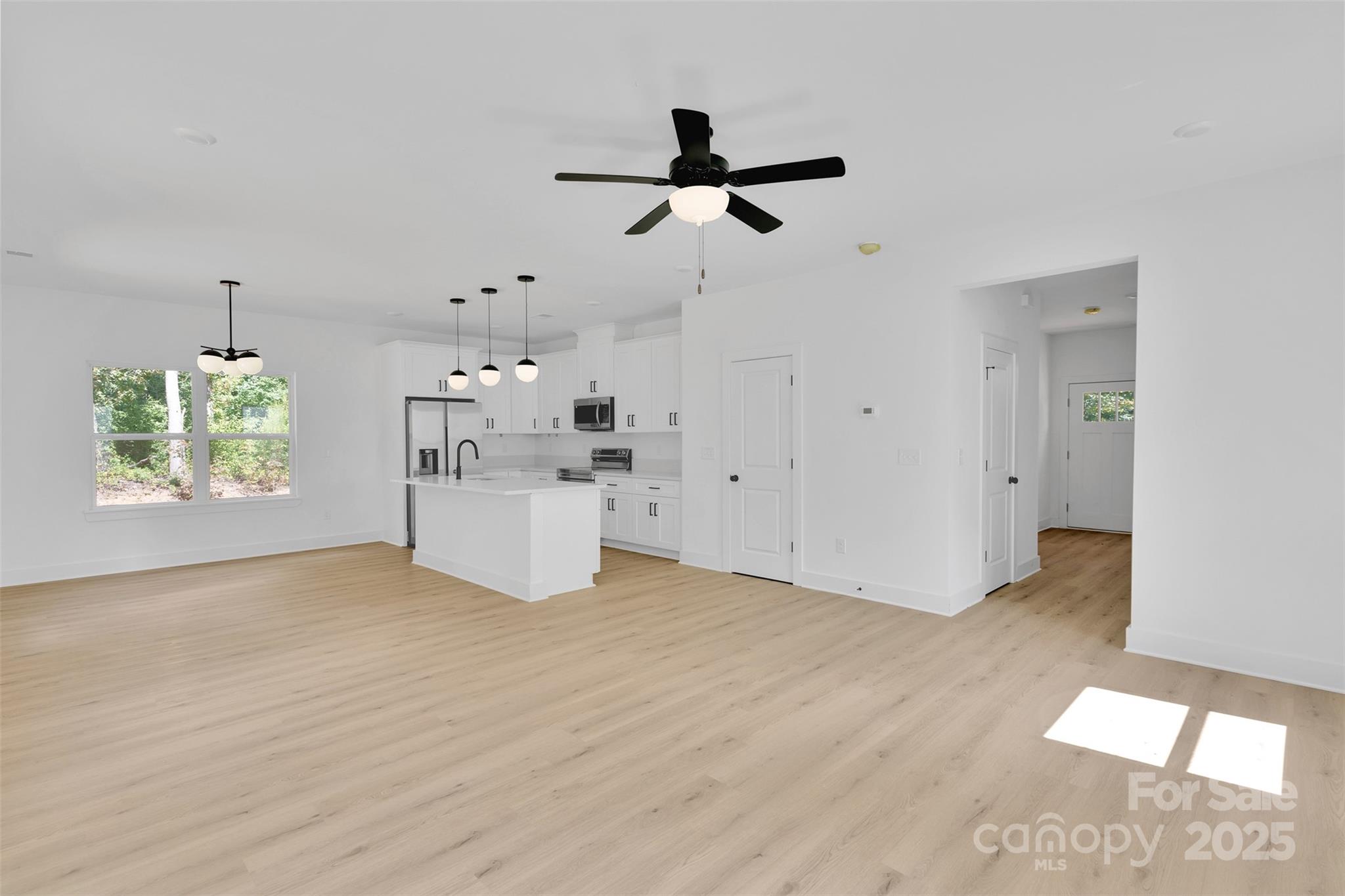 3549 Lake Road Charlotte, NC 28269 - Photo 10 of 34 a view of empty room with wooden floor and window