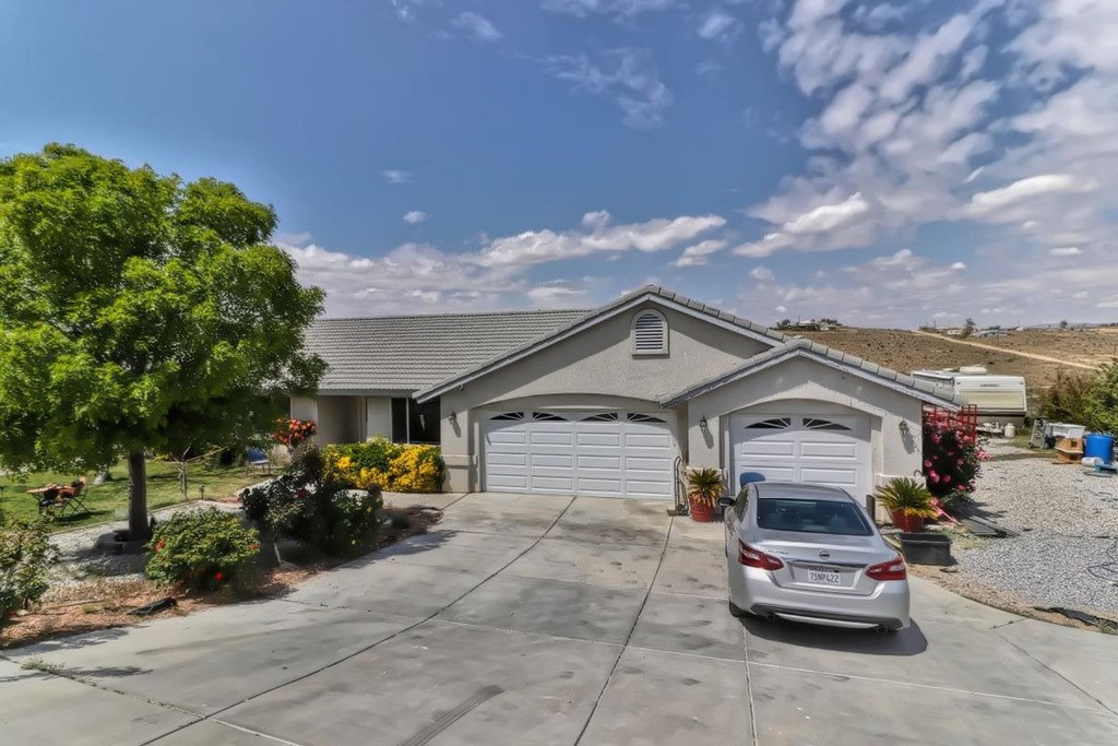 21828 Outpost Road Apple Valley, CA 92308 - Photo 1 of 1 a car parked in front of house
