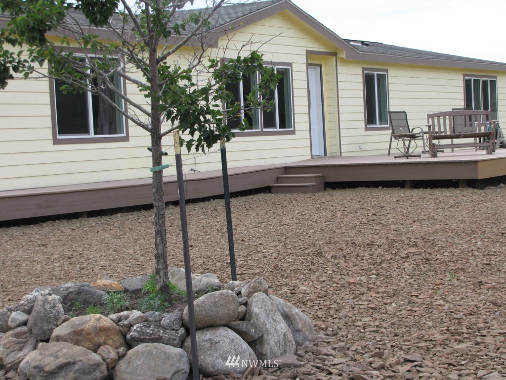 29 Duck Flat Road Tonasket, WA 98855 - Photo 5 of 18 a view of a house with a backyard and couches