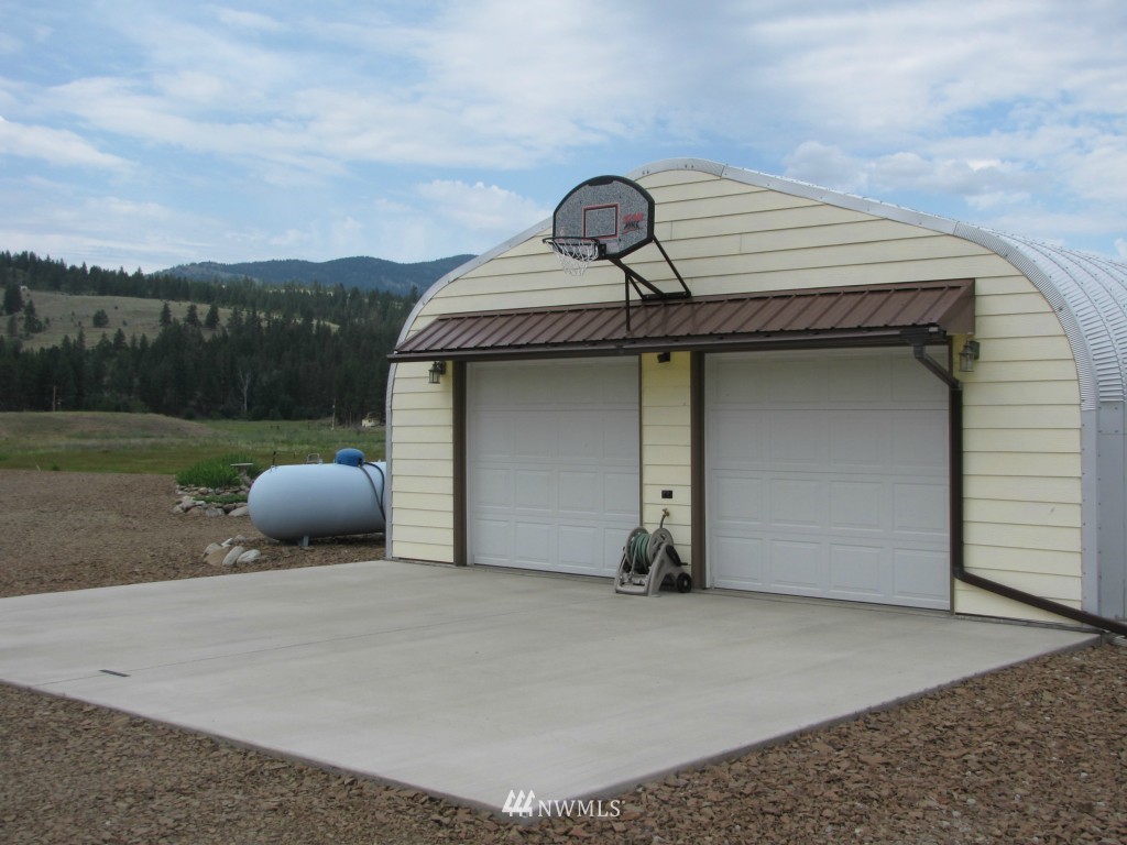29 Duck Flat Road Tonasket, WA 98855 - Photo 6 of 18 a front view of a house with mountain