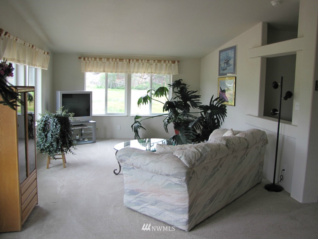 29 Duck Flat Road Tonasket, WA 98855 - Photo 10 of 18 a living room with furniture and a flat screen tv