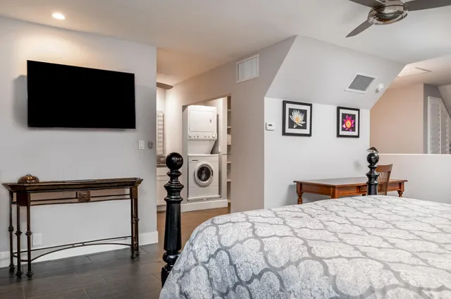 a bedroom with a bed and a flat screen tv