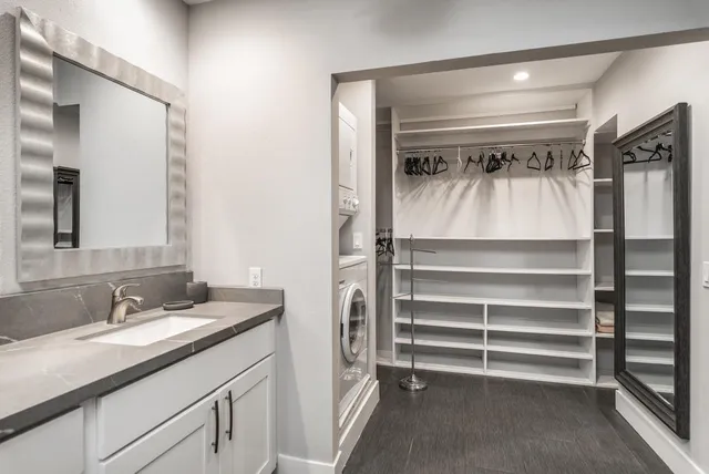a bathroom with a shower sink and mirror
