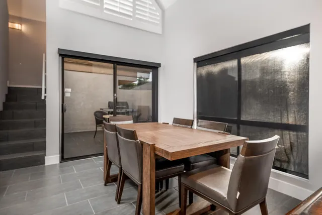 a dining room with furniture and window