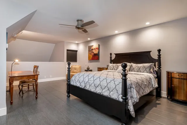 a large bed sitting in a bedroom and table