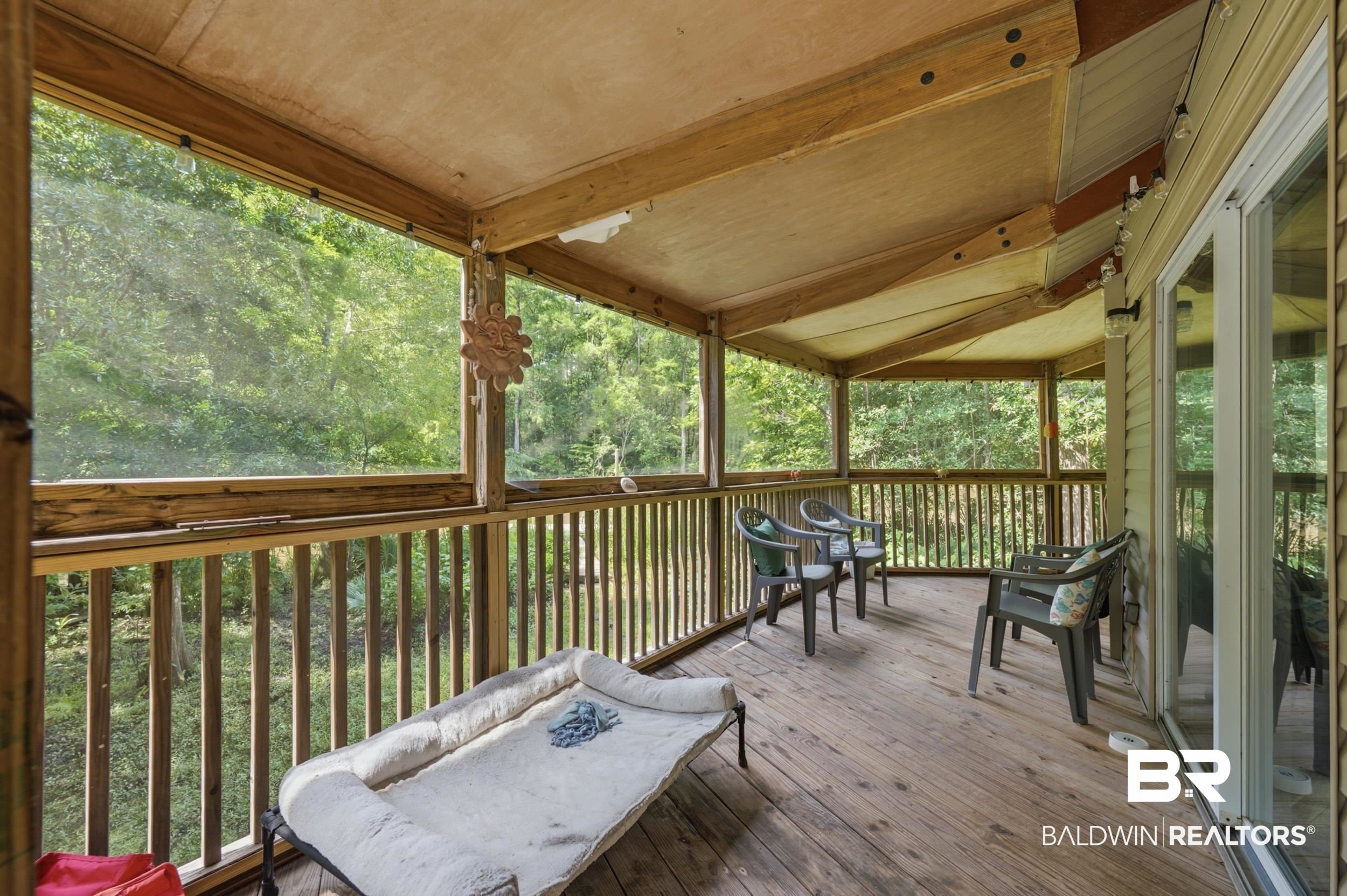 42080 Bayou Road Bay Minette, AL 36507 - Photo 9 of 43 Screened porch featuring wood-finish decking and natural wood railing