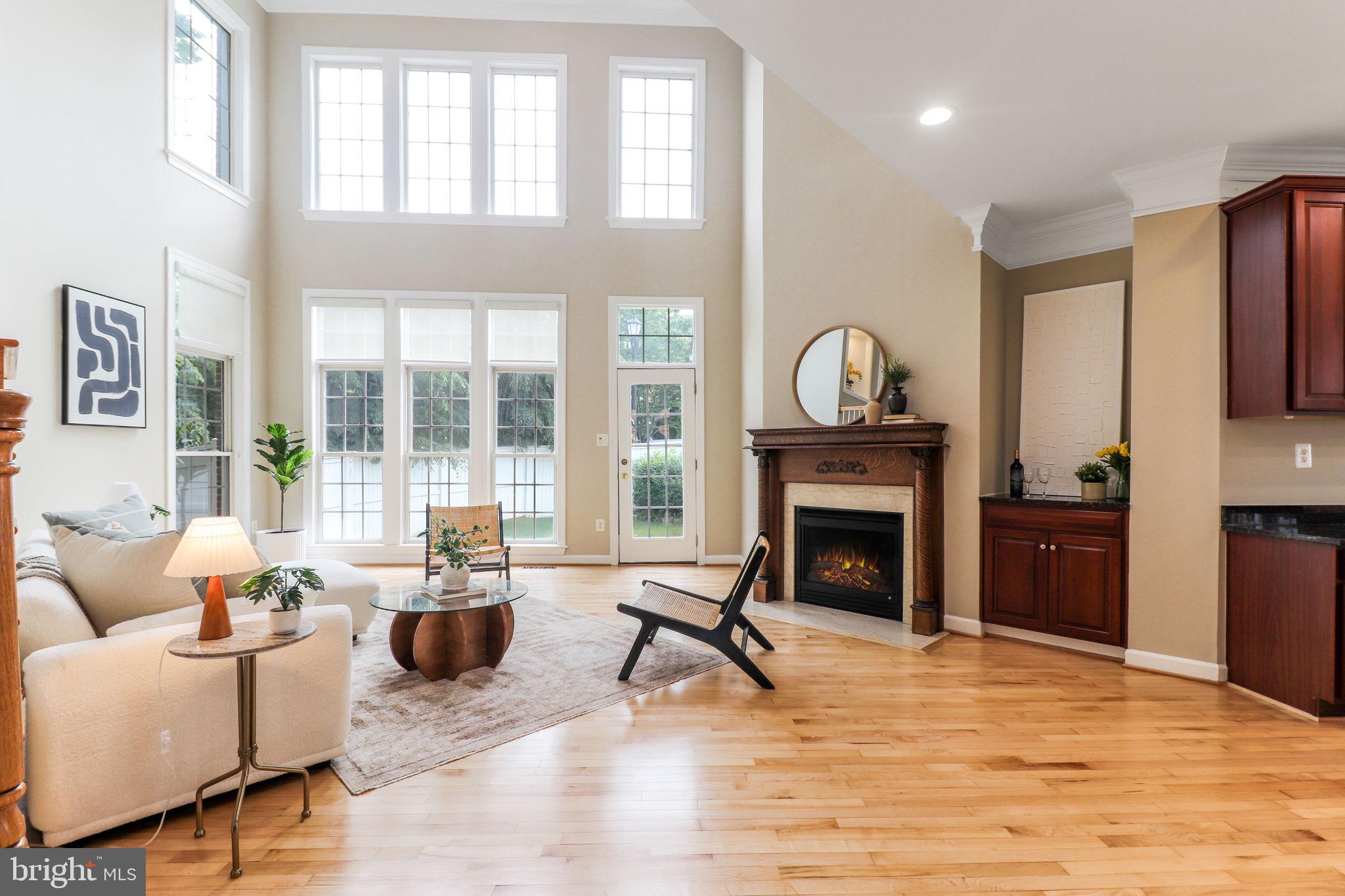 710 Crisfield Way Annapolis, MD 21401 - Photo 13 of 80 a living room with furniture a fireplace and a floor to ceiling window
