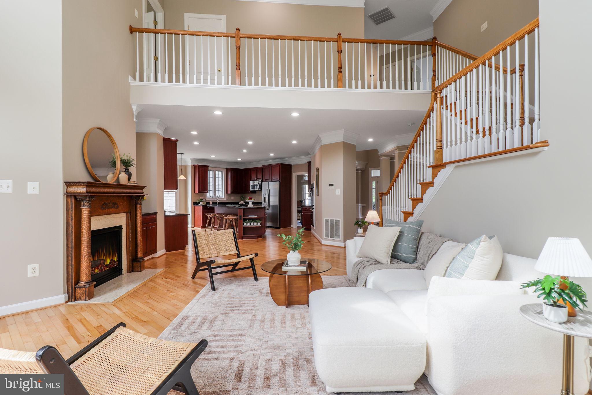 710 Crisfield Way Annapolis, MD 21401 - Photo 15 of 80 a living room with furniture a fireplace and a book shelf