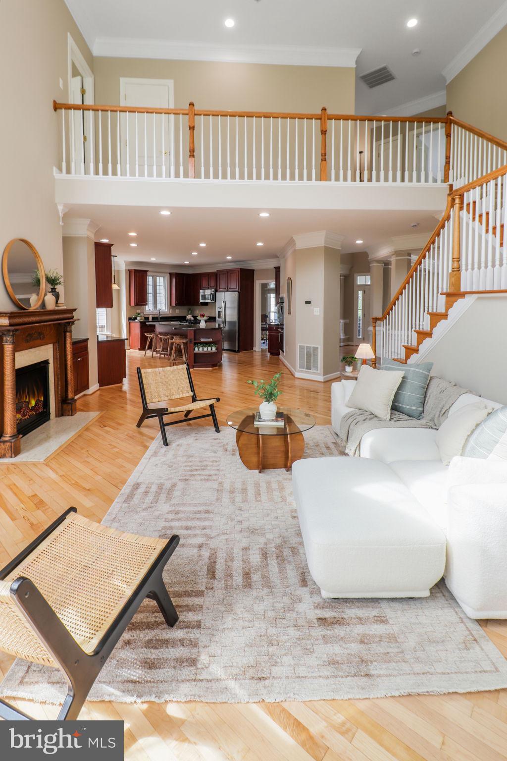 710 Crisfield Way Annapolis, MD 21401 - Photo 16 of 80 a living room with furniture a fireplace and a book shelf