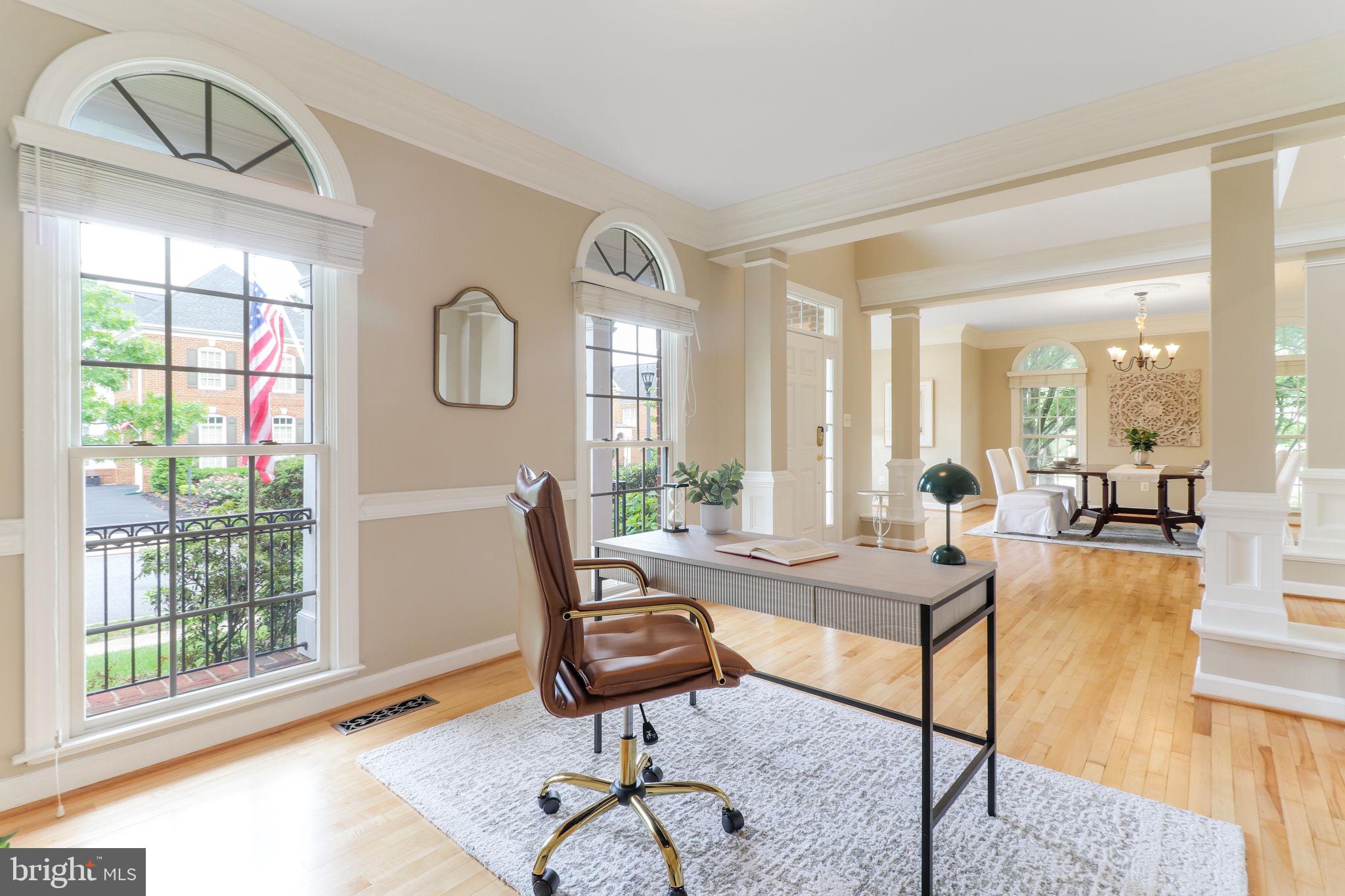 710 Crisfield Way Annapolis, MD 21401 - Photo 23 of 80 a living room with furniture a table and large windows