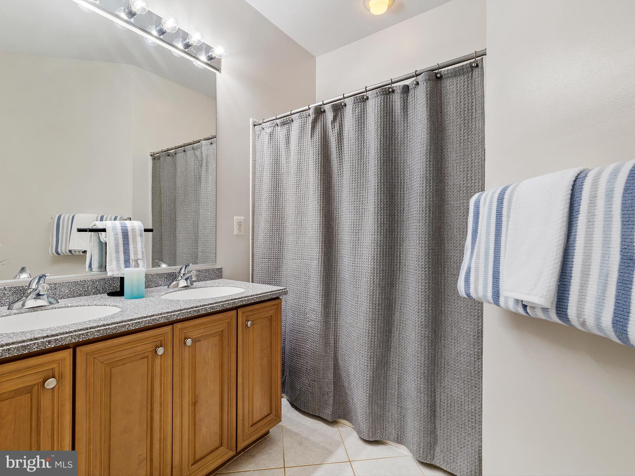 710 Crisfield Way Annapolis, MD 21401 - Photo 45 of 80 a bathroom with a granite countertop sink and a mirror