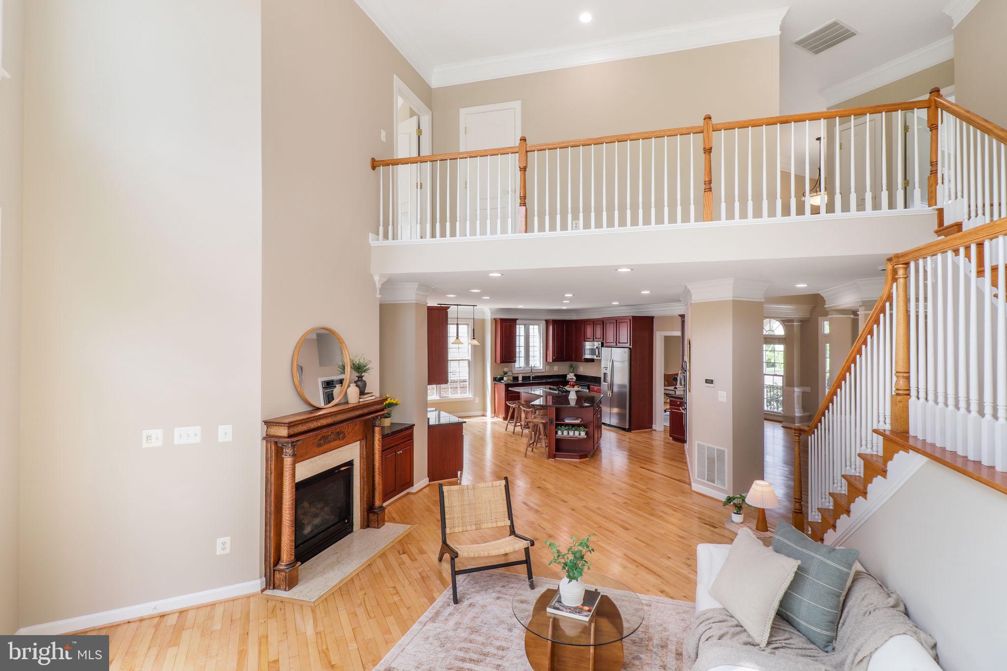 710 Crisfield Way Annapolis, MD 21401 - Photo 6 of 80 a living room with furniture a fireplace and a book shelf