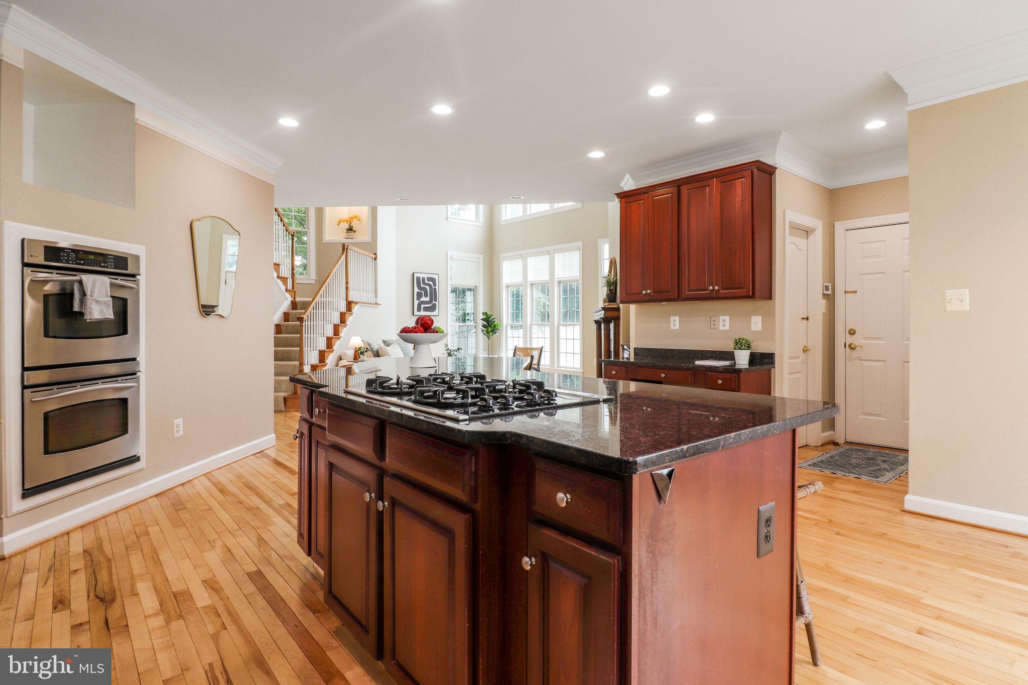 710 Crisfield Way Annapolis, MD 21401 - Photo 9 of 80 a kitchen with stainless steel appliances granite countertop a stove top oven a sink dishwasher and a refrigerator with wooden floor