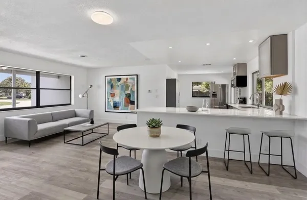 a kitchen with a table and chairs in it