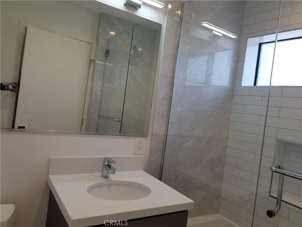 231 North Burlington Avenue Echo Park, CA 90026 - Photo 7 of 10 a bathroom with a sink a toilet and shower