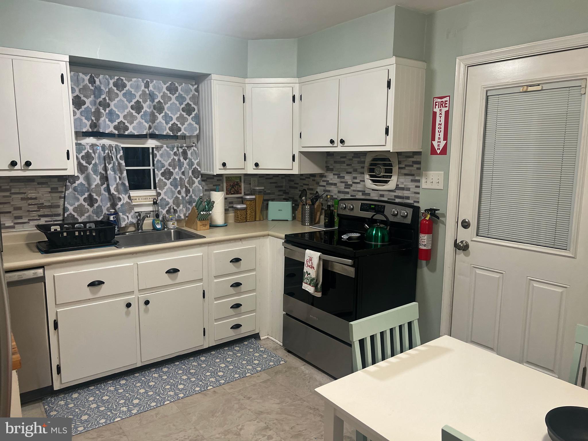 321 Timberline Drive Mount Laurel, NJ 08054 - Photo 3 of 14 a kitchen with stainless steel appliances a stove and white cabinets