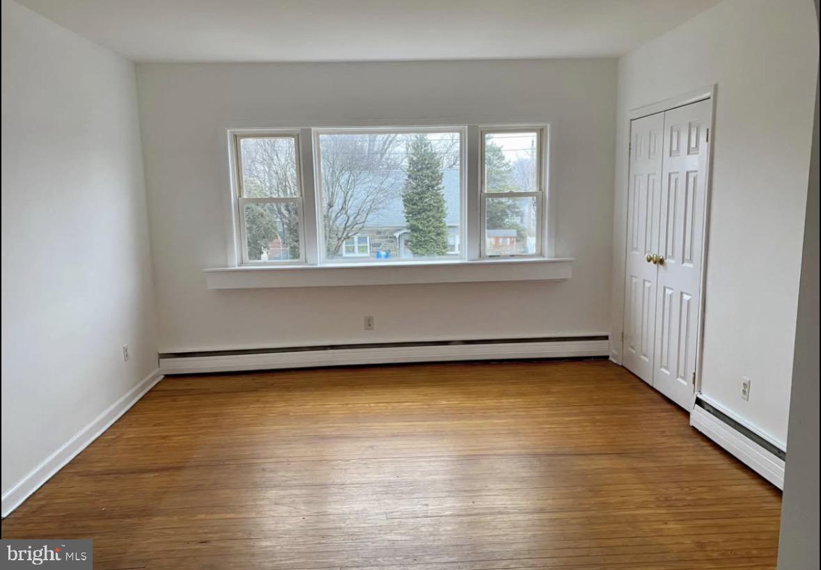 672 Colwell Road Woodlyn, PA 19094 - Photo 4 of 5 wooden floor in an empty room with a window