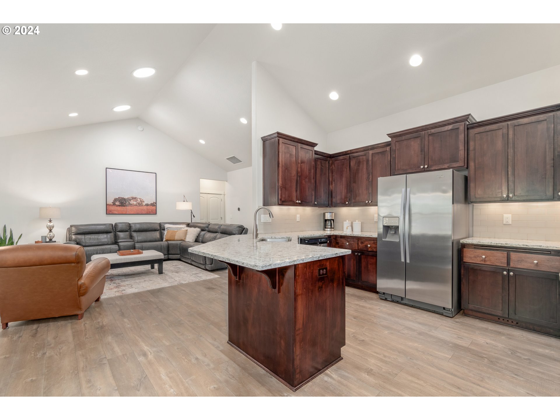3622 Stark Street Eugene, OR 97404 - Photo 12 of 48 a kitchen with stainless steel appliances granite countertop a sink a stove a refrigerator and a dining table with wooden floor