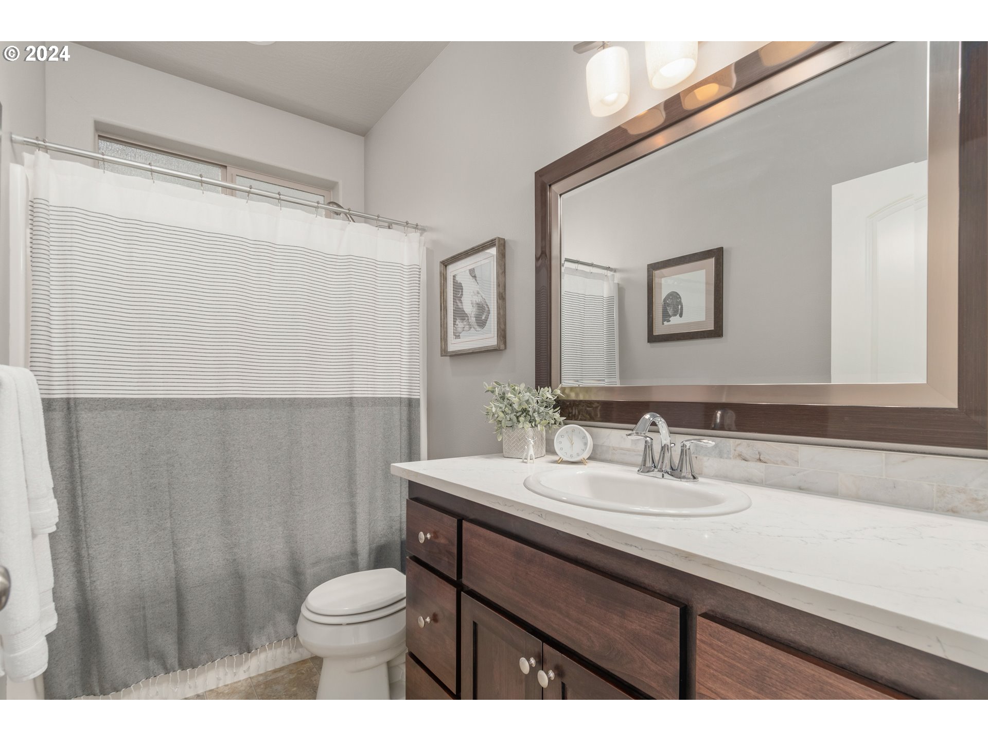 3622 Stark Street Eugene, OR 97404 - Photo 27 of 48 a bathroom with a sink a toilet a mirror and shower curtain