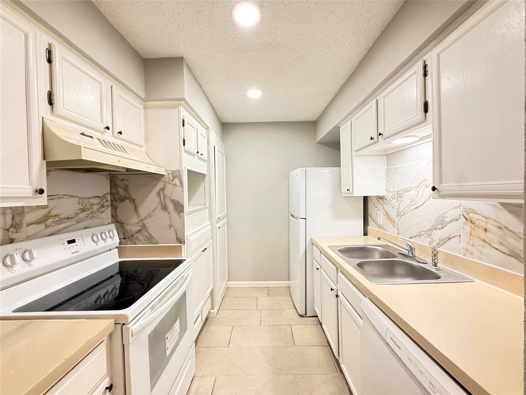 9696 Walnut Street, Unit 813 Dallas, TX 75243 - Photo 11 of 21 a kitchen with stainless steel appliances granite countertop a sink and a stove